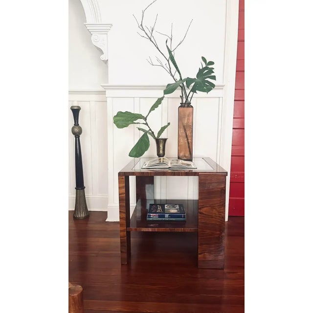 1920s Hungarian Bauhaus occasional table in lacquered walnut veneer with two tier design and lower shelf of bookmatched...