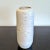 A beautiful, snow-white, cylindrical vase from the East German studio of master potter Albert Kießling. The texture left...