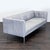 This Room & Board 3-seat sofa features a modern design with clean lines and a sleek gray leather upholstery. Its tufted...