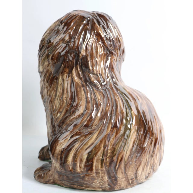 Cute glazed ceramic statue of a long hair dog, I believe it's a Pekingese breed, but am not an expert. Free of damage, or...