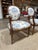 Elegant matched pair of Louis XVI style fauteuils — the classic French neoclassical open-arm chair, with beautifully...