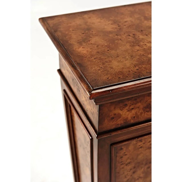 A Classical poplar burl panel tapered pedestal, with a square top and a stepped plinth base. The original Louis XVI....