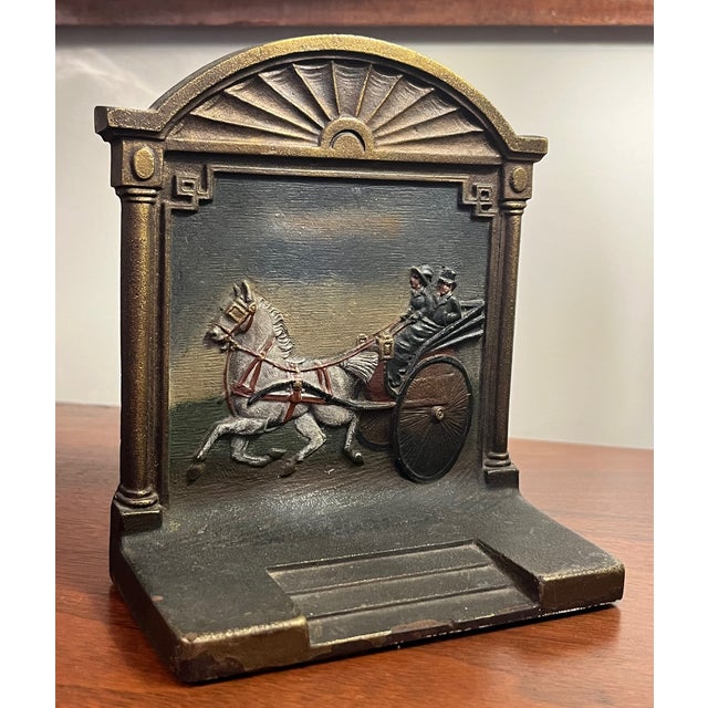 Beautifully hand painted heavy cast iron bookend depicting a Victorian single horse carriage with a woman driver. Bookend...