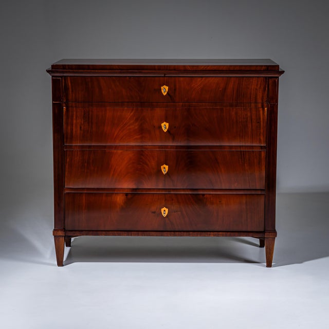 Biedermeier writing chest veneered in mahogany with three drawers and a fall-front writing compartment. The interior is...
