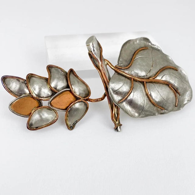 Fabrice, Paris designed this gorgeous floral brooch. The rare piece features a massive, polished pewter-copper leaf and a...