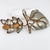 Fabrice, Paris designed this gorgeous floral brooch. The rare piece features a massive, polished pewter-copper leaf and a...
