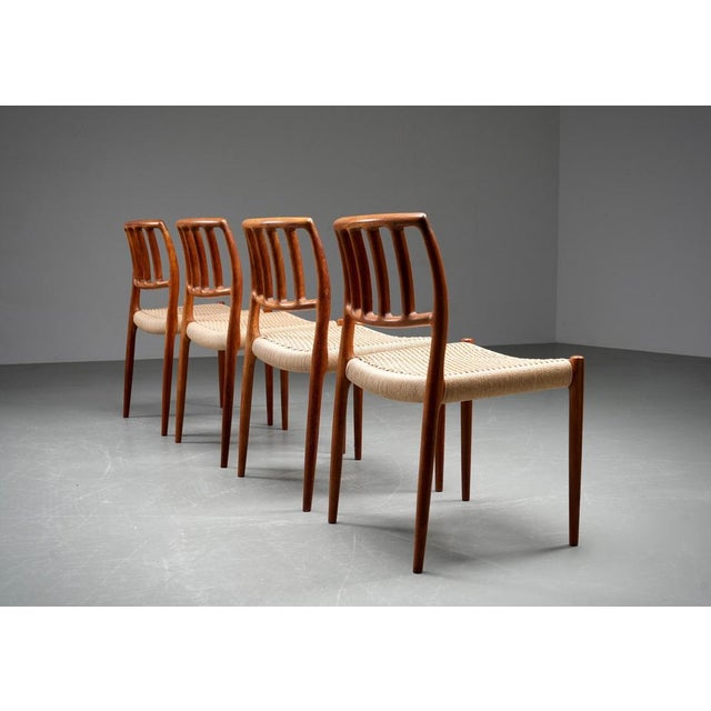 Set of four mid-century modern dining chairs in solid teak and woven cord seats, Denmark, 1960s. A refined and sculptural...