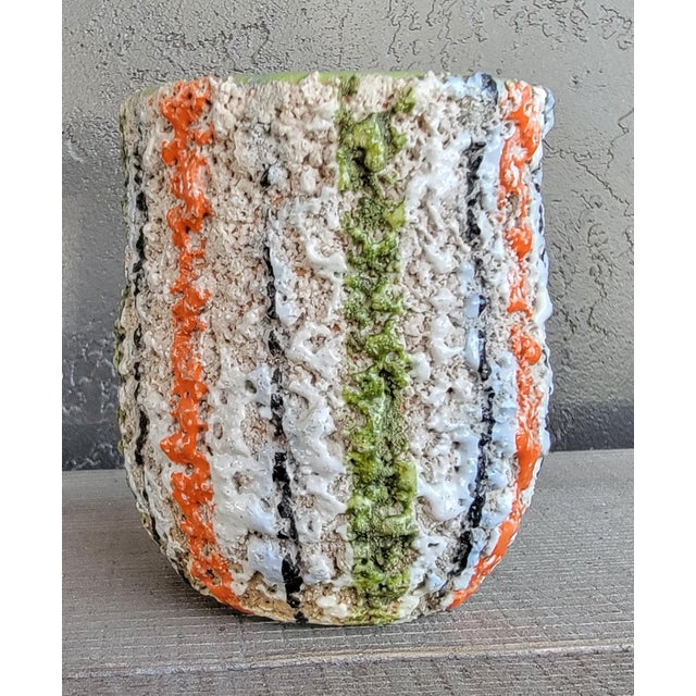 A small pottery vase / planter with a very bubbly and colorful lava type glaze. Appears to be either West Germany or...