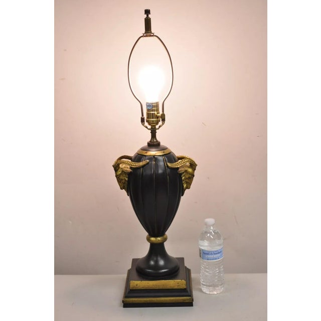 Decorator Chelsea House Neoclassical Style Black & Gold Cast Fiberglass Table Lamp w/ Rams. Circa Late 20th Century....