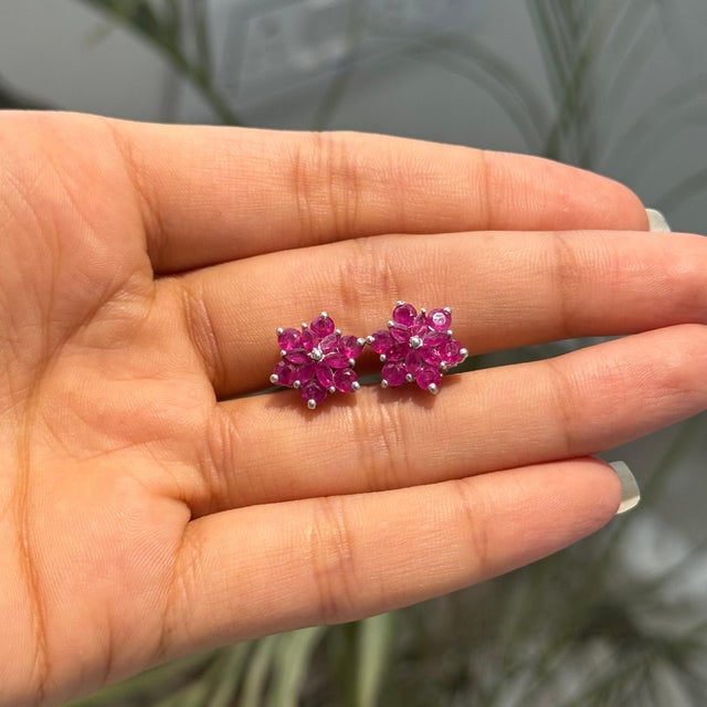 These rosette flower cluster stud earrings are crafted in 925 sterling silver and feature 2.9 carats of natural ruby in a...