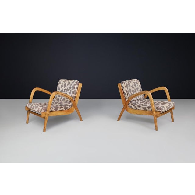 Pair of Jan Vaněk Curved Easy Chairs in Ash with Original Upholstery, Czechoslovakia, 1950s A beautifully preserved pair...