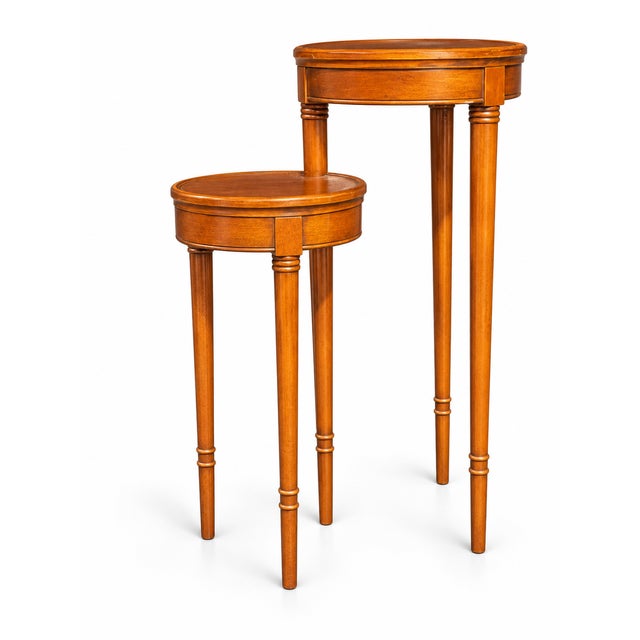 Two tiered candle stand that has two tables conjoined by one central leg that allows you to swivel the smaller table...