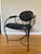 Uncommon maybe one-of-a-kind tufted leather and metal armchair. Bent metal is wrought iron hammer tone powder coated. This...