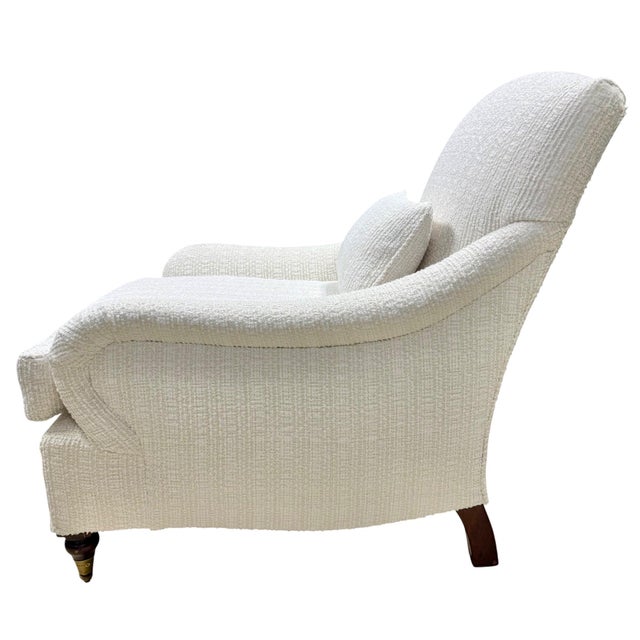 Classic armchair upholstered in a luxurious cream bouclé fabric, offering a soft texture and relaxed elegance. Designed...