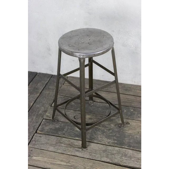 American Industrial factory stool with original green paint and polished metal seat. Sold in good vintage condition Ref #:...