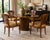 A stylish set of four vintage dining chairs by Henredon featuring elegant cane backs, sculptural walnut-toned frames, and...