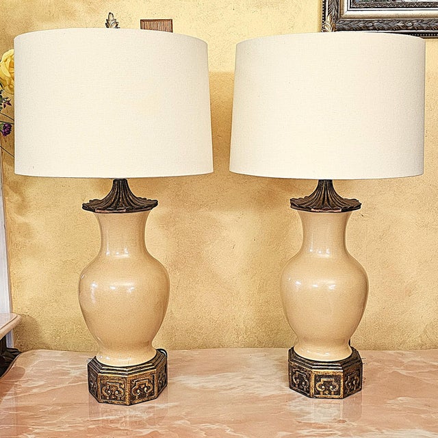 Pair of authentic Port 68 ceramic table lamps designed by Mark Abrams. Features include glossy cream urn-form bodies,...