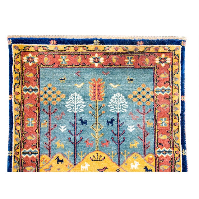 A playful mid-20th century Persian Bidjar pictorial rug depicting a mountainous landscape with myriad birds, deer, and...