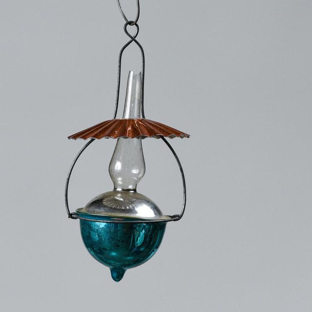 This charming 1950s italian christmas lantern-shaped ornament is a charming example of vintage decoration reflecting...