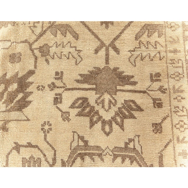 This magnificent antique Turkish Oushak rug from the 1920s captures the essence of Anatolian craftsmanship with a serene...