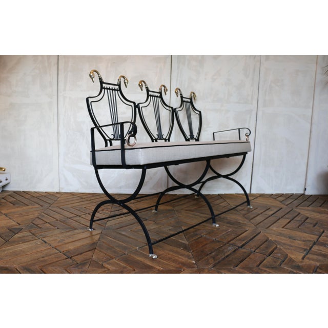 A striking and highly sculptural iron settee attributed to Samuel Copelon, France, circa 1950s. This elegant mid-century...