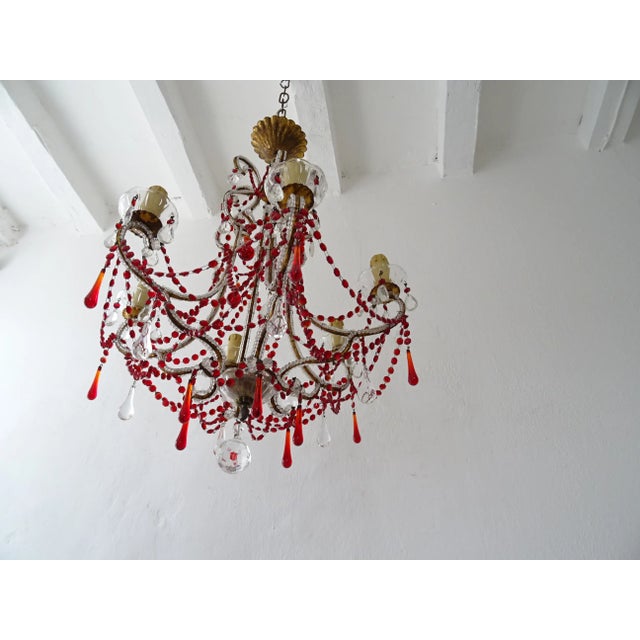 Housing six lights sitting in crystal bobeches dripping with vintage crystal prisms. Will be rewired with certified UL US...