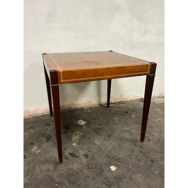 Beautiful leather top game table with gold embossed trim. Nicely tapered leg giving a modern tradition style. Curbside...