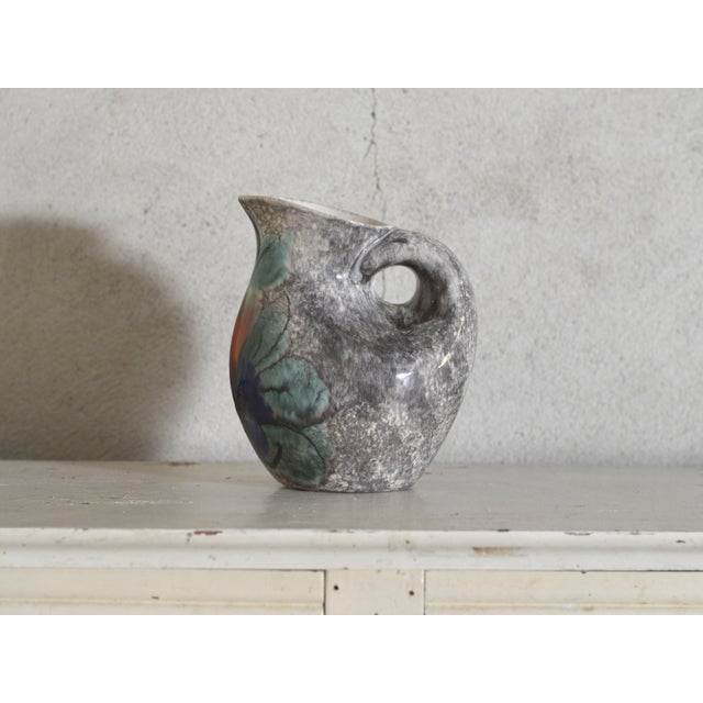 A beautiful vintage French ceramic pitcher dating from the 1950s, showcasing a distinctive handcrafted glaze in mineral...