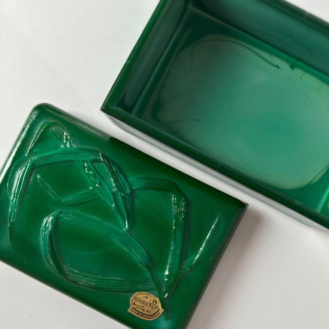 A richly coloured malachite glass trinket box, crafted in Czechoslovakia during the mid-20th century, circa 1950s. This...