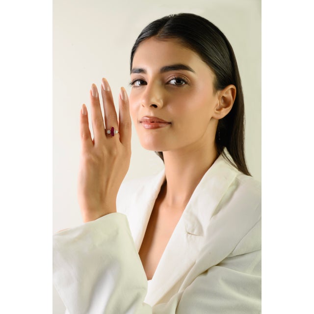 This elegant three-stone ring features 1 marquise cut natural ruby totaling 1.29 carats, set in rich 14k yellow gold. The...