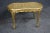 Louis XV style cane boudoir/vanity bench in gilt wood with carved frame and cabriole legs.