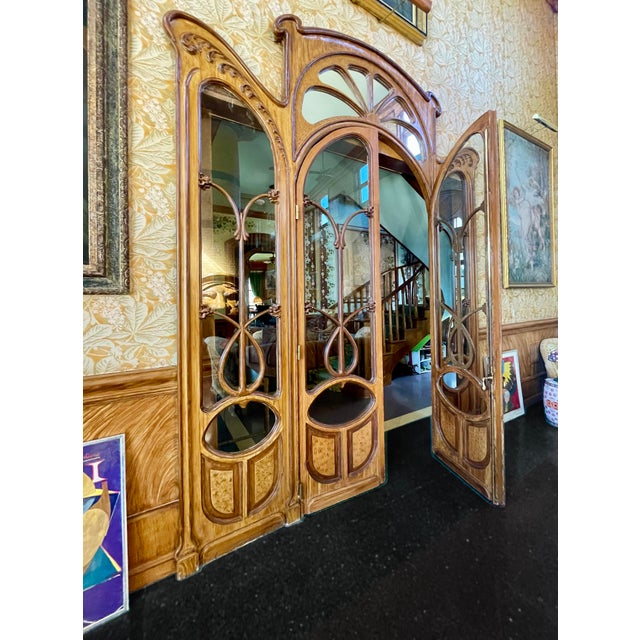 Spectacular antique Art Nouveau doorway in the manner of Hector Guimard. Sidelight panels are fixed and the pair of...