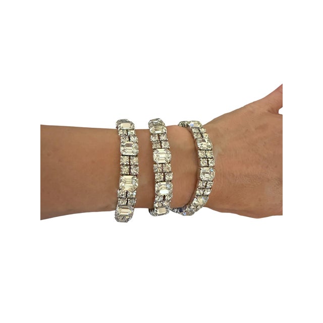 This stunning Art Deco-style bracelet features a classic geometric aesthetic, characterized by its symmetrical arrangement...