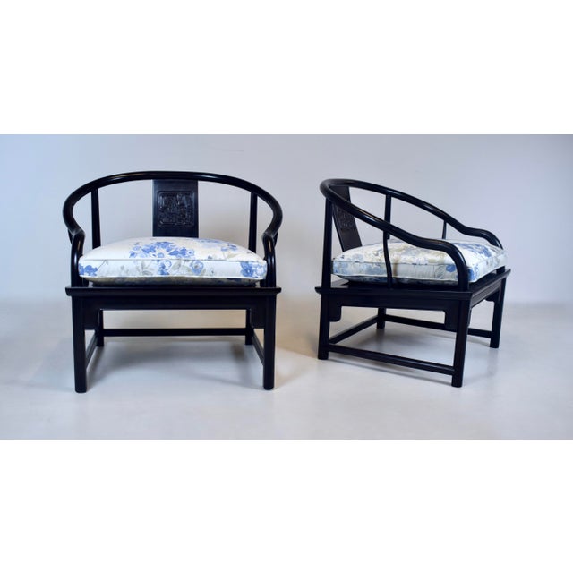 An impressive pair of solid Ebony Mid 20th Century Chinoiserie lounge chairs with distinct specs and influences pre-...