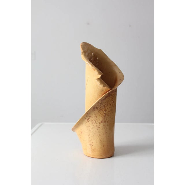 A vintage free-form studio pottery vase, hand-crafted and signed by the artist. The sculptural silhouette is inspired by...