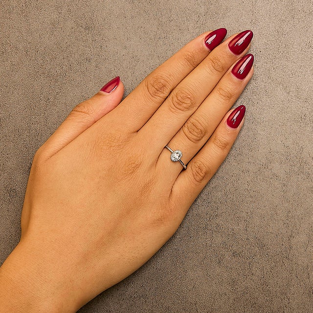 Elegant and radiant, this exquisite ring is a symphony of color and light, masterfully crafted from rhodium-plated 10K...