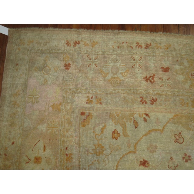 An early 20th Century Oversize Hand-knotted Turkish Oushak with an all-over design on a neutral field. Professionally...