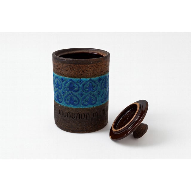 An Italian canister jar by Bitossi, decorated with textured bands and glazed accents in the Rimini Blue style. The...
