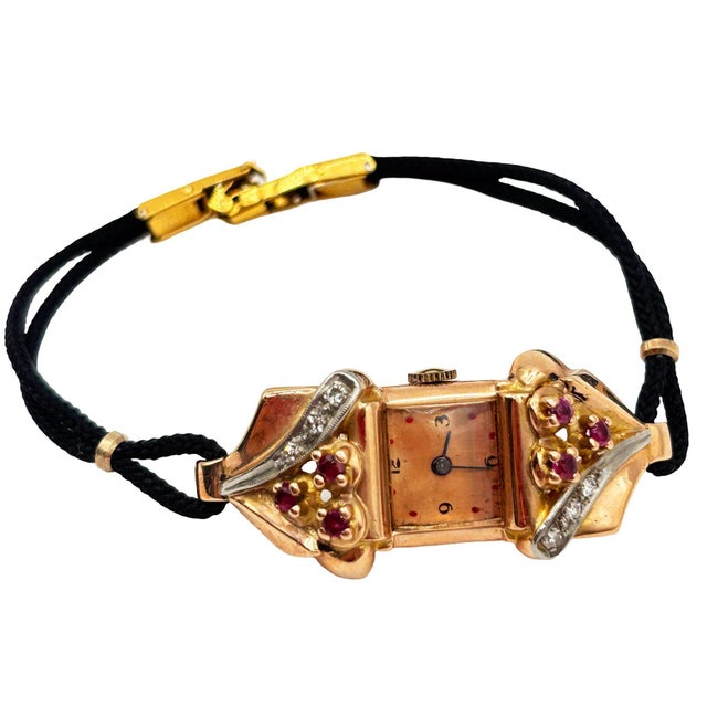 An elegant Art Deco ladies’ cocktail wristwatch, crafted in 14K gold with floral ruby and diamond accents. The rectangular...