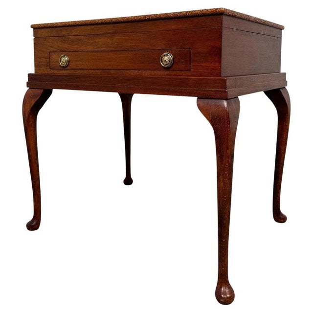 A charming early 20th-century English box on stand, finely crafted from mahogany and distinguished by its elegant cabriole...