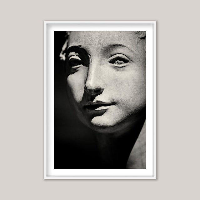A sepia-toned black and white photograph of Portrait of a Young Woman, an Italian plaster cast after the work of...