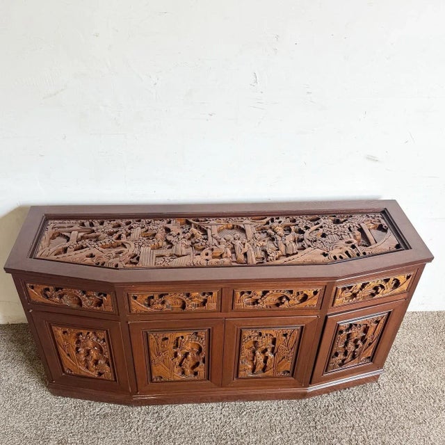 Enhance your home with the intricate beauty of this Asian Wooden Hand Carved Credenza. This exquisite piece features...