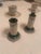 These are decorative porcelain candlesticks featuring a neoclassical column design. It showcases ornate polychrome...