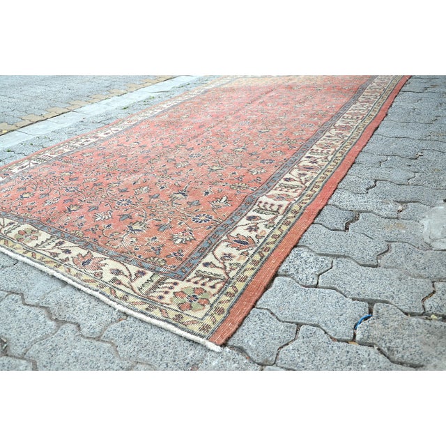 This is a vintage Turkish Oushak rug from the 1960s. The piece was hand-knotted.