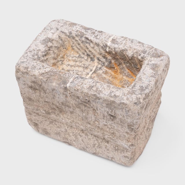 Hand-carved from a solid block of limestone, this rustic stone vessel is an antique Chinese incense burner from the 19th...