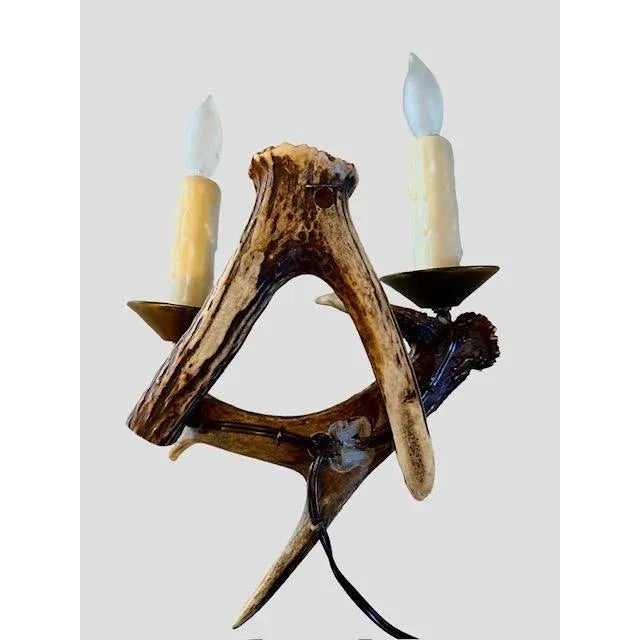Antler wall sconce with switch on cord. Made with roe deer antlers. Candle covers over sockets.