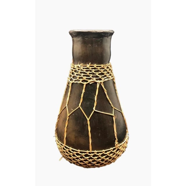 A lovely vintage hand carved and wrapped vessel