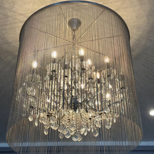 A shimmering veil of ball chain adds an industrial touch to the Victorian design of our opulent crystal glass and iron...