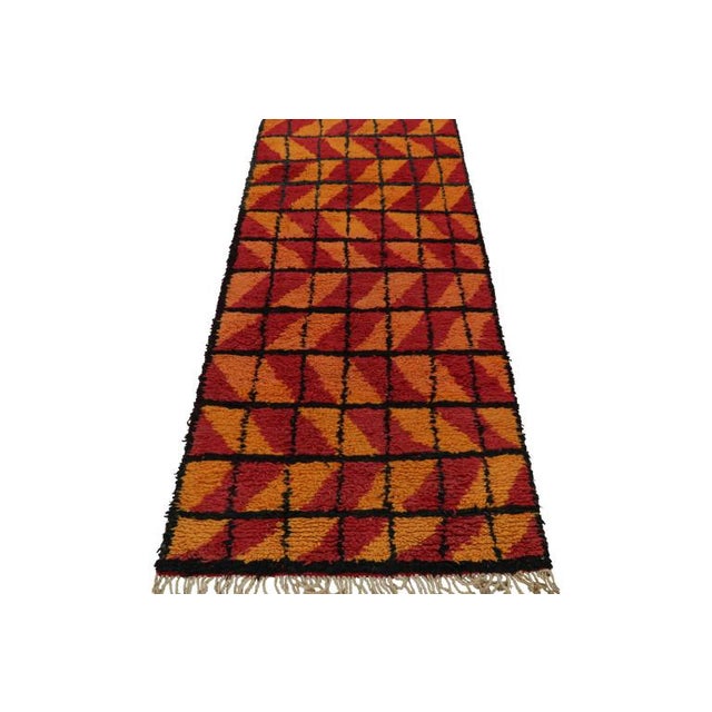 Hand-knotted in wool and originating from Morocco circa 1950-1960, this 3x7 vintage Moroccan rug is an extremely rare...