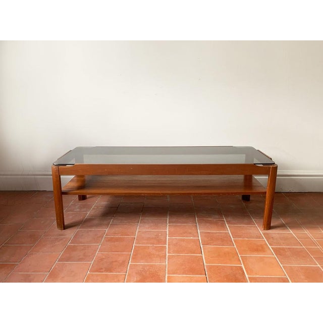 Mid century modern coffee table by respected English maker ‘Myer’. Solid countered teak frame with thick smoked glass...